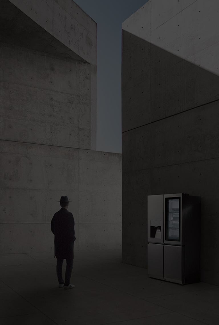 creator and photographer of minh tran is standing in front of lg signature refrigerator and staring it in the overall unique architectural site