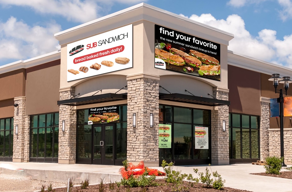 Largescale outdoor signage and window signage can work together to show branding and entice visitors