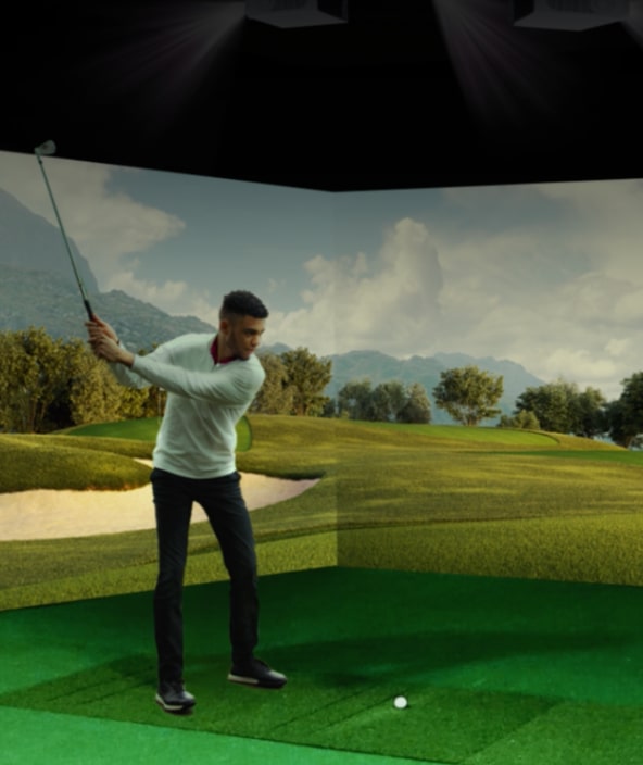Man playing in golf simulator