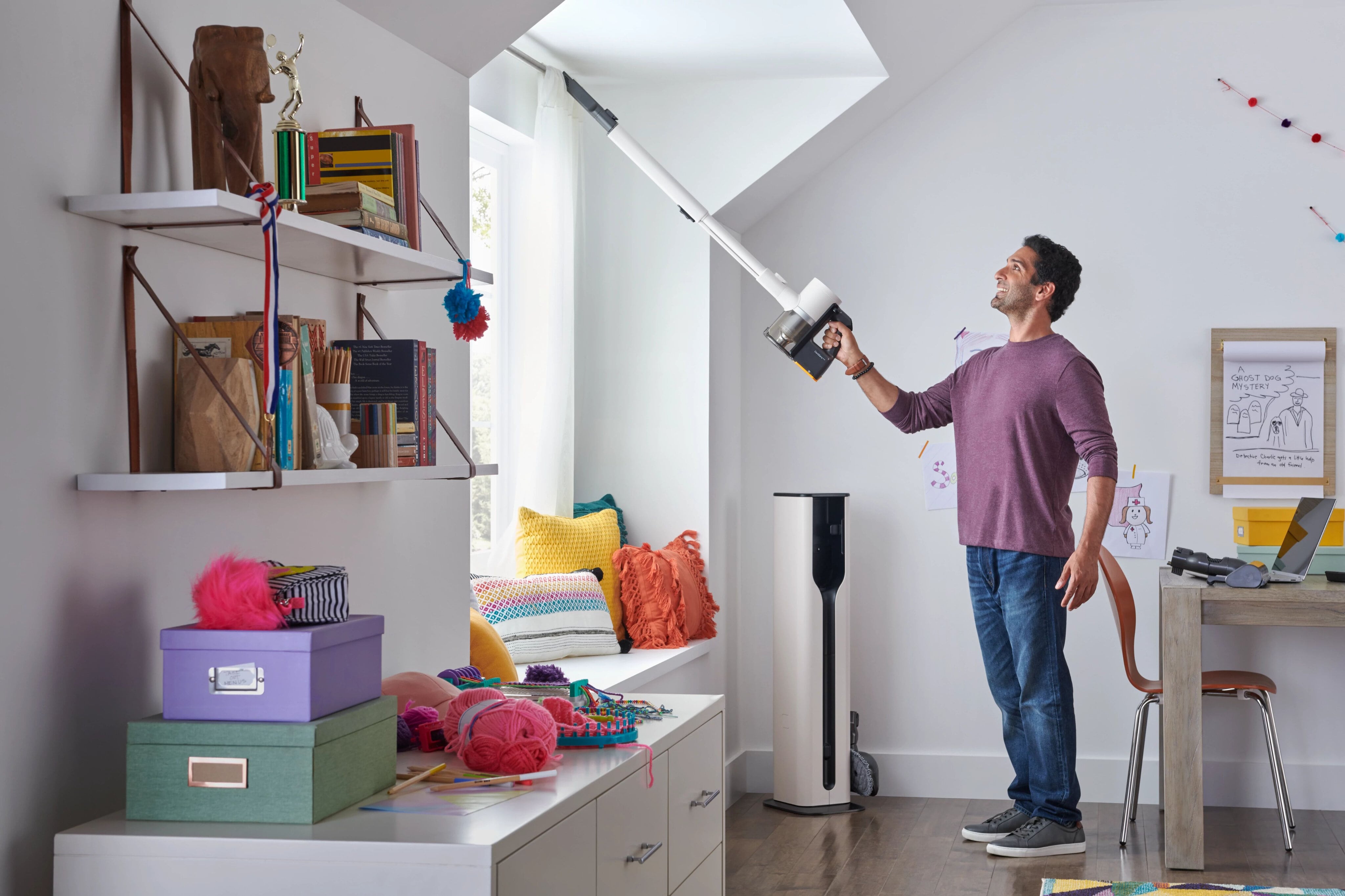 Man using LG Vacuum with telescopic handle to clean dust on curtains