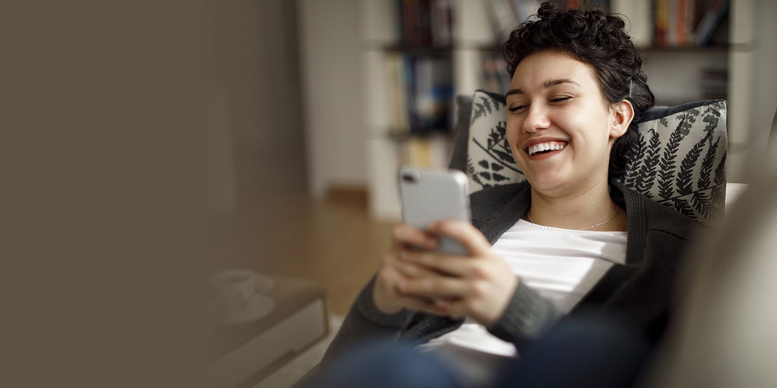 ThinQ App - woman laughing looking at her phone