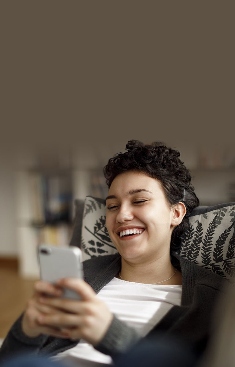 ThinQ App - woman laughing looking at her phone