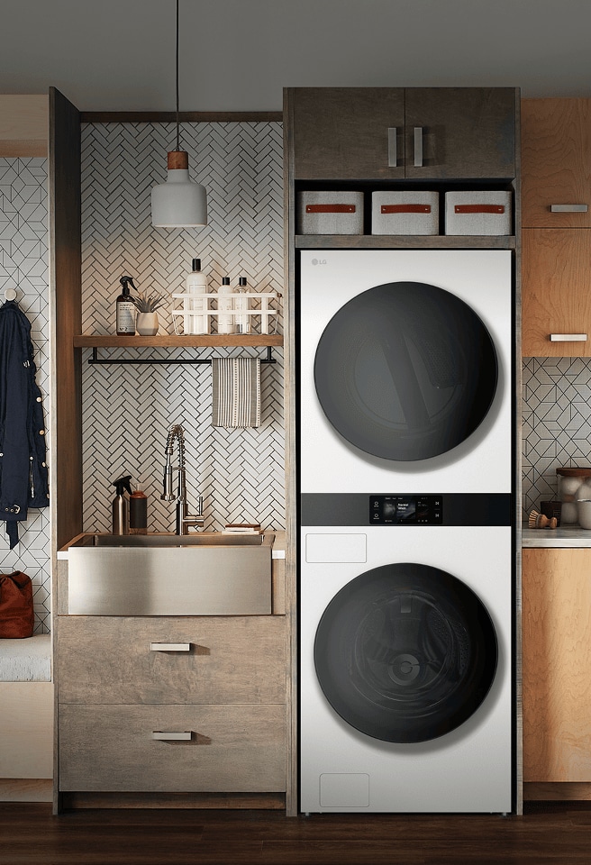 LG WashTower AI — a built-in stacked washer and dryer combo featuring AI DD™ technology, installed in a modern laundry room with warm wood cabinetry and bench seating.