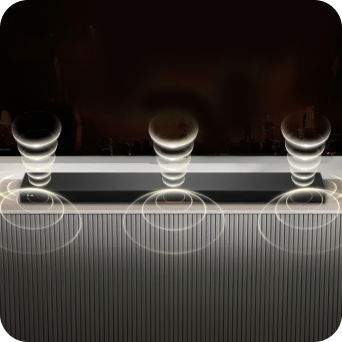 A soundbar emitting rich, immersive sound wave patterns from its top and bottom.