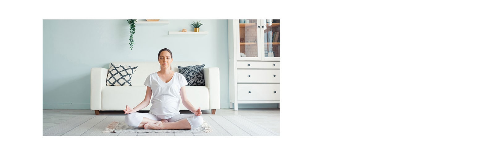 a woman does a meditation in her living room