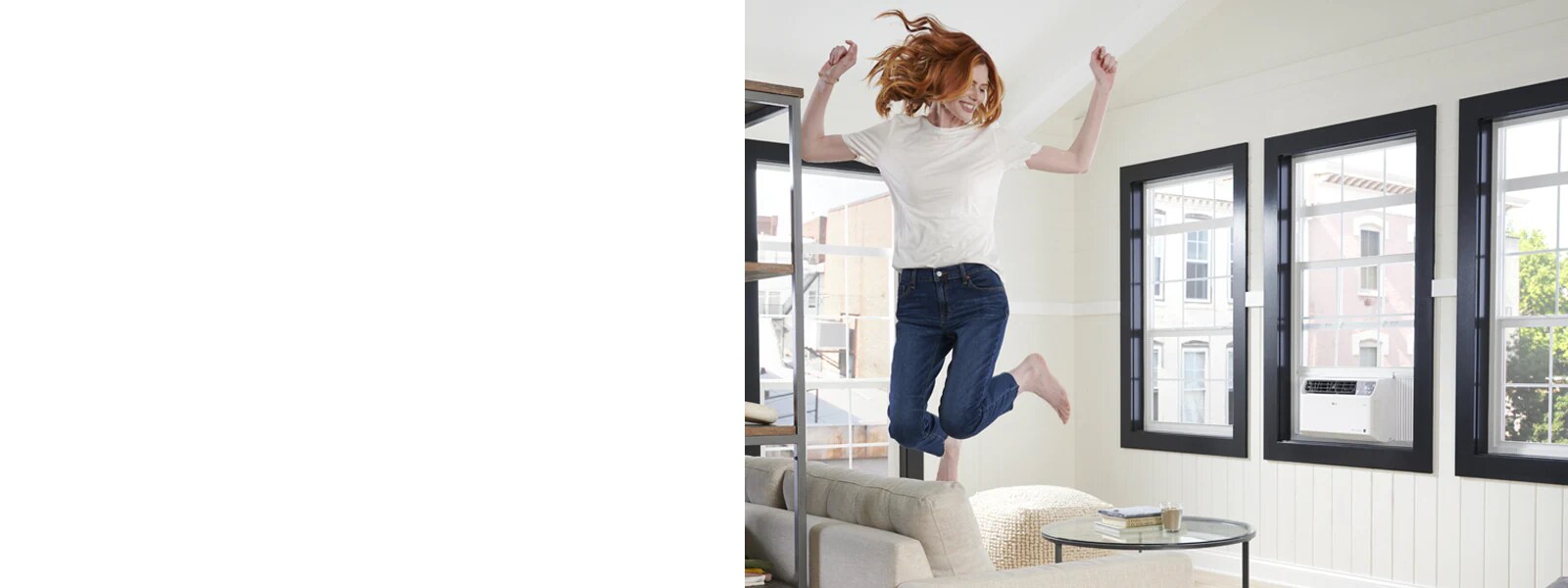 LG window air Conditioner in a living room and a woman jumping on a sofa