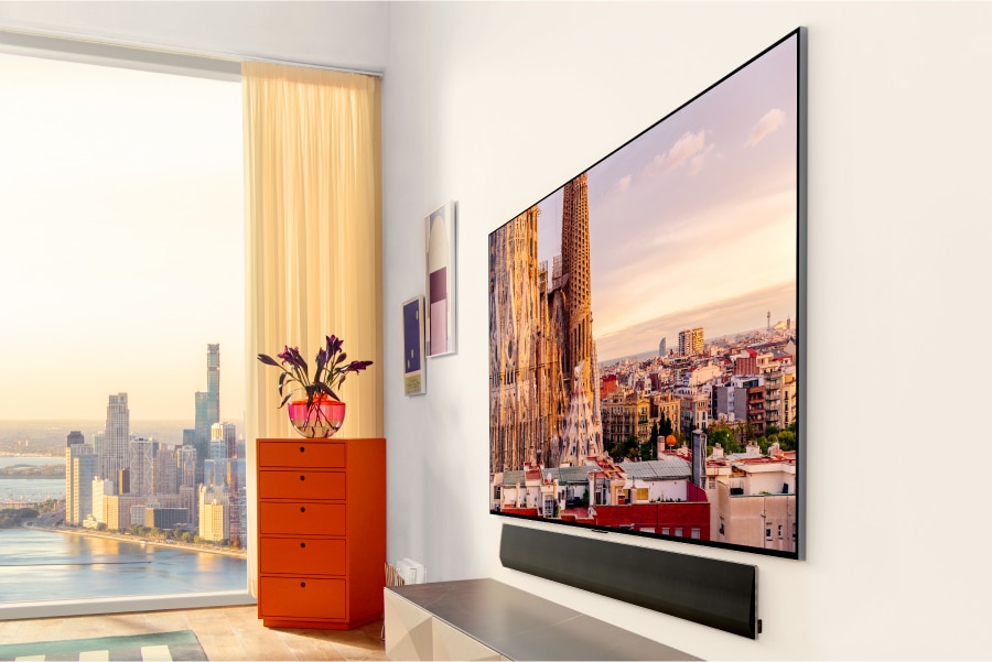 A TV and sound bar seamlessly mounted to the wall.