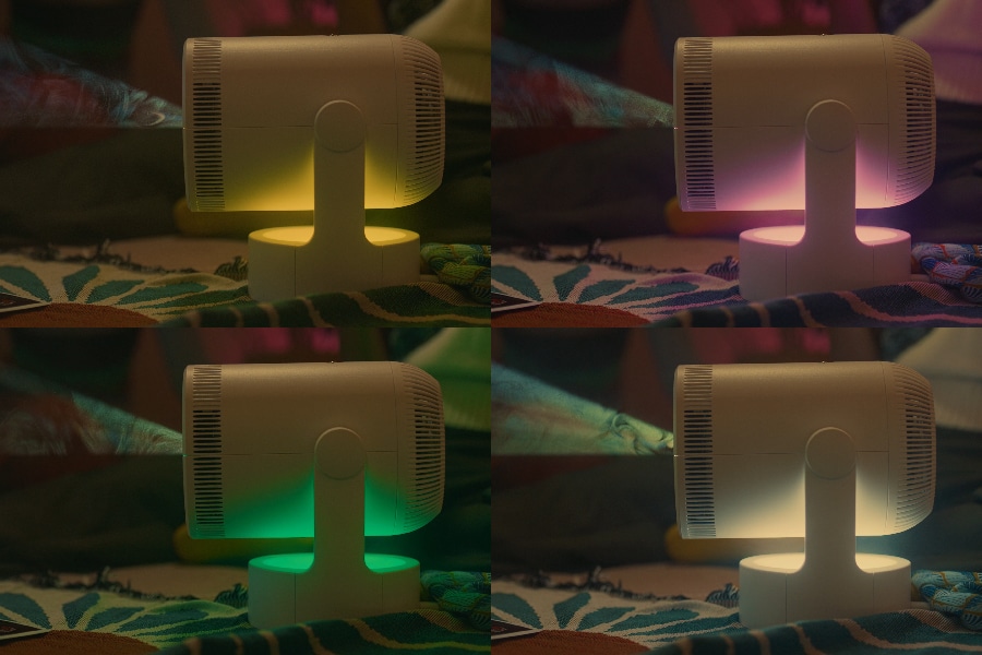 The projector glows with yellow, purple, green then white light. 