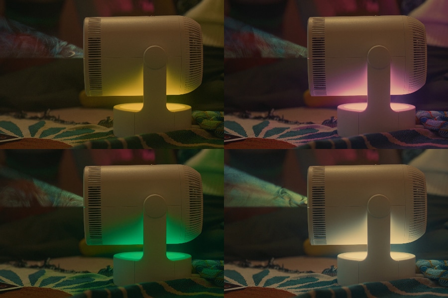 The projector glows with yellow, purple, green then white light.