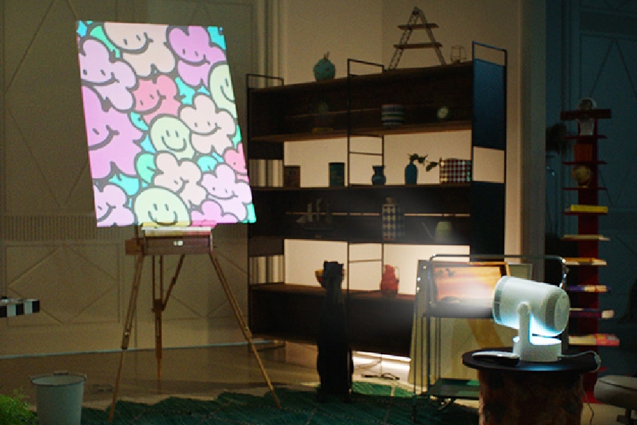 A projector projects an artistic image on an easle.