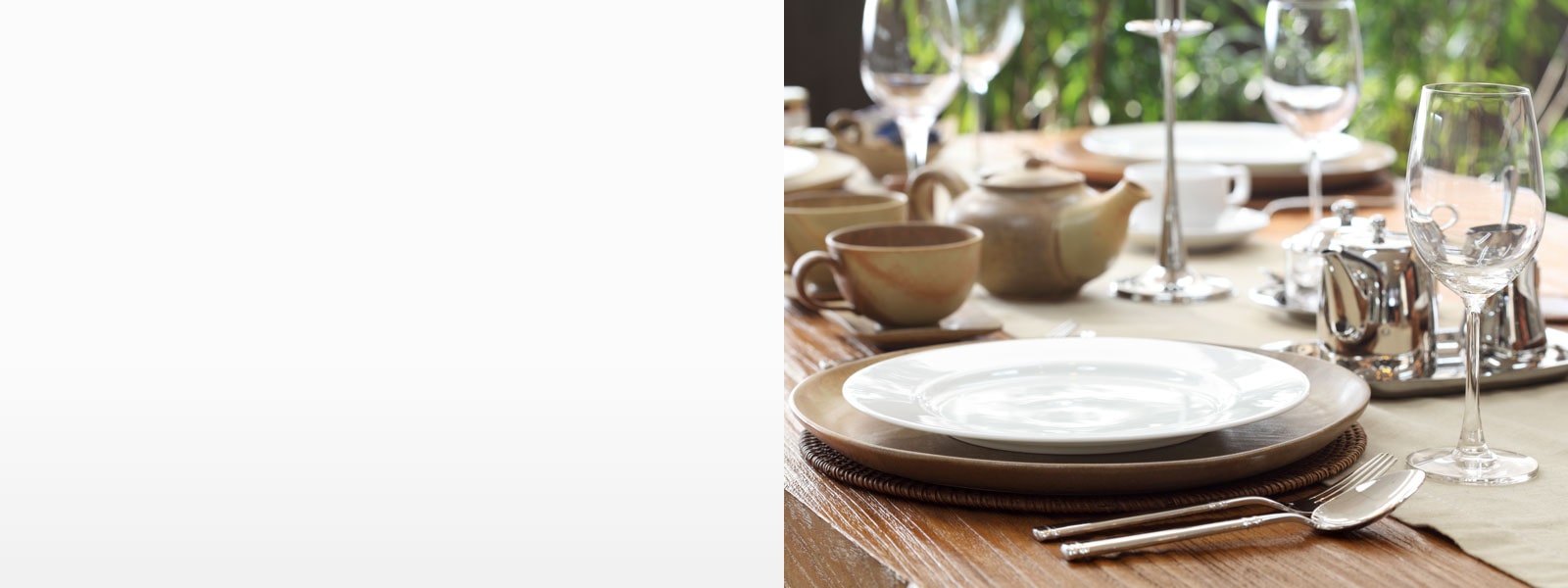 A sparkling table with sanitized dishes and glasses.
