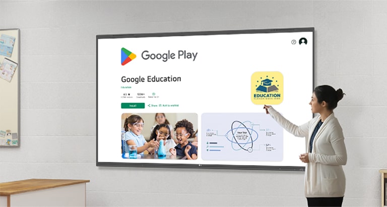 A woman is using LG CreateBoard to browse the Google Play Store, downloading educational apps.