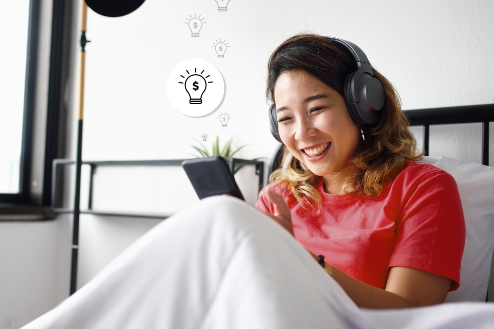 A woman using her smartphone on her bed