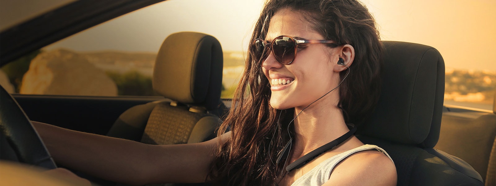 woman wearing lg tone while driving