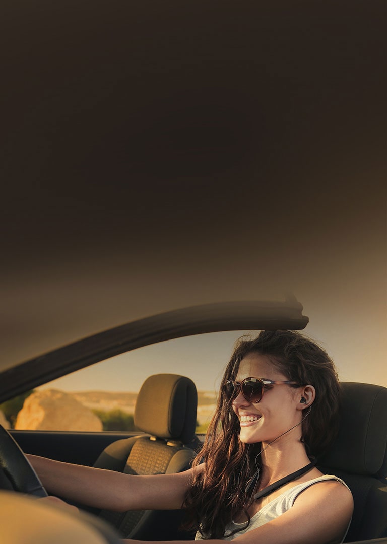 woman wearing lg tone while driving