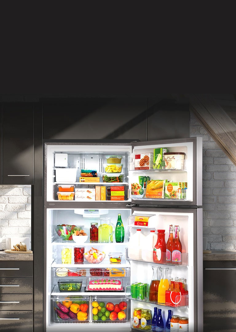 Open LG Refrigerator filled with food highlighted by sunlight in a kitchen