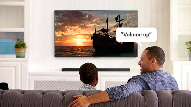 A man asking TV, “Volume up” to hear louder