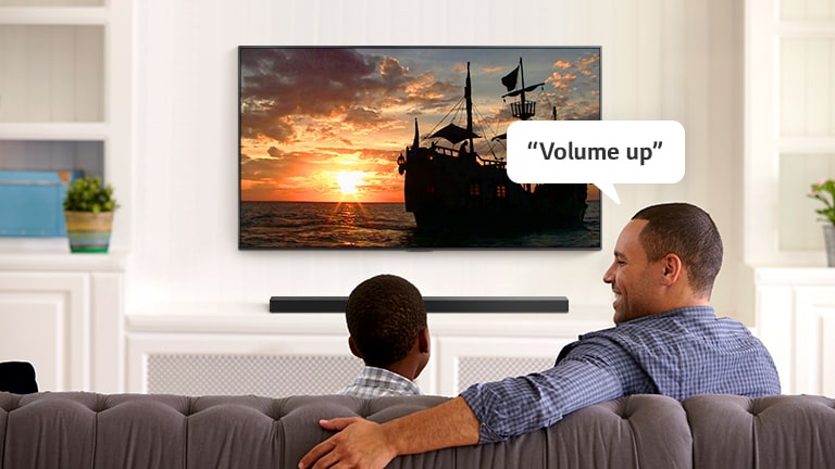 A man asking TV, "Volume up" to hear louder