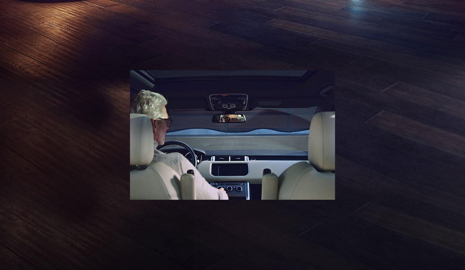 Man in driver's seat changing stations on the car radio