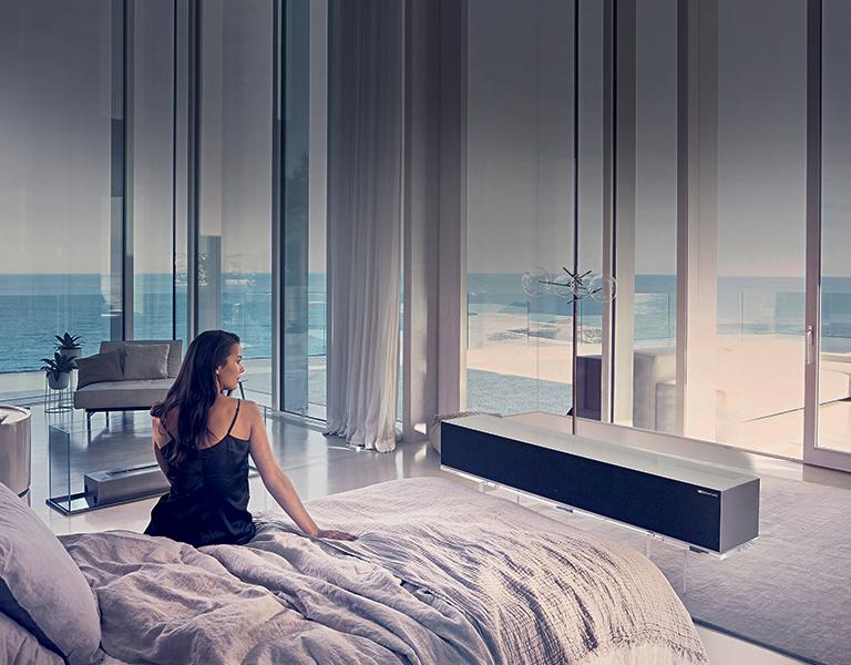 Woman watching TV in a luxury bedroom