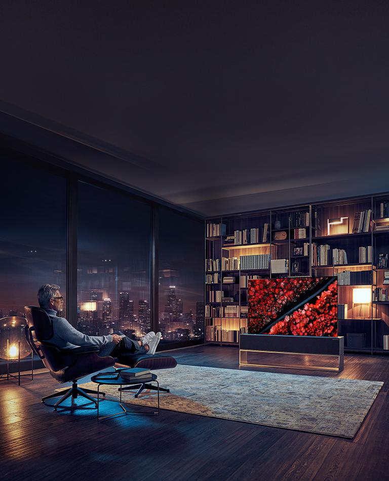 Man watching TV in a luxury living room.