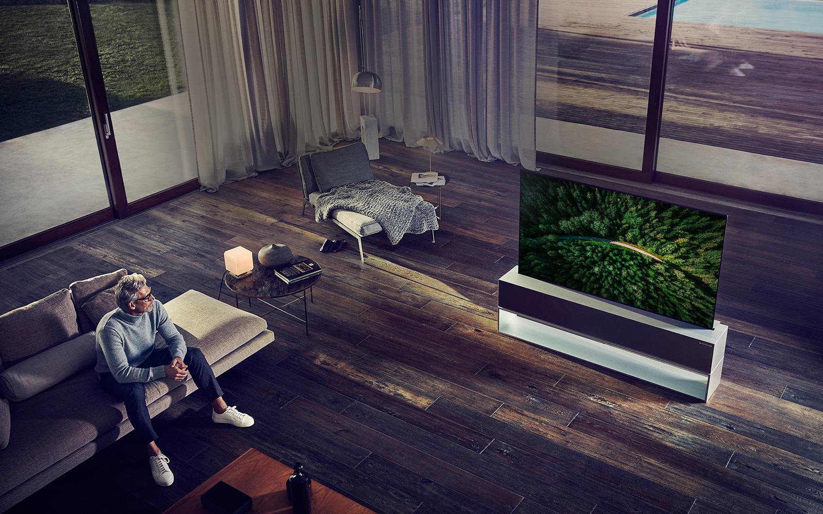 Man watching TV in a luxury living room.