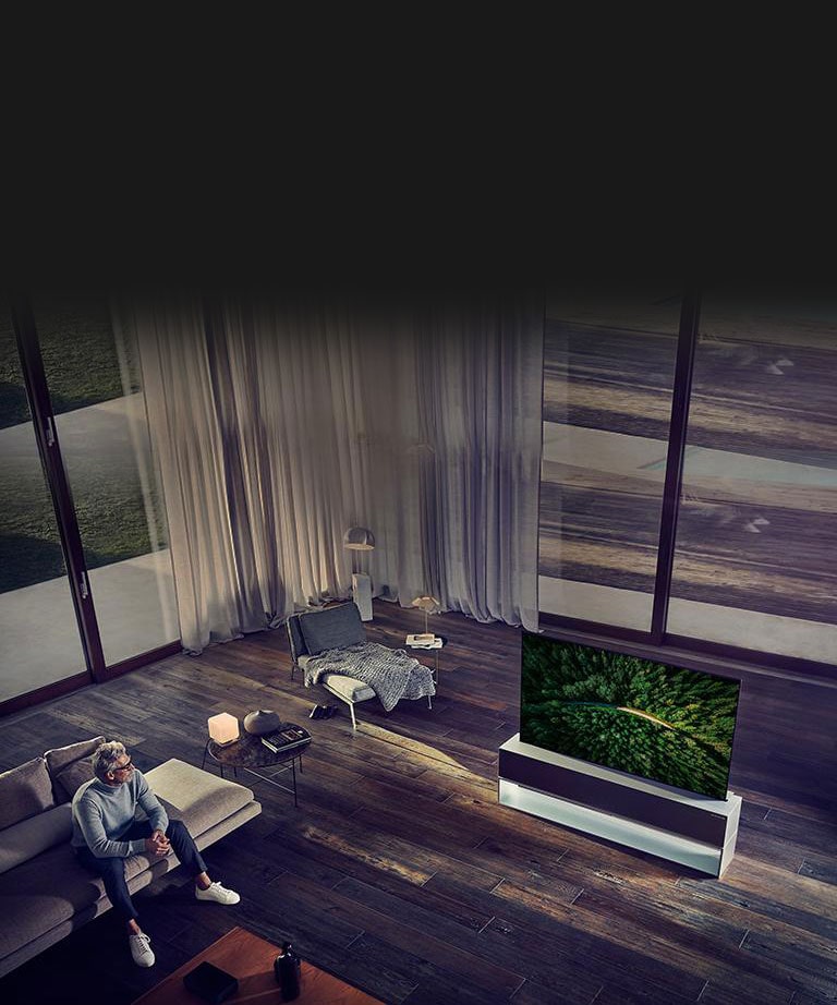 Man watching TV in a luxury living room.