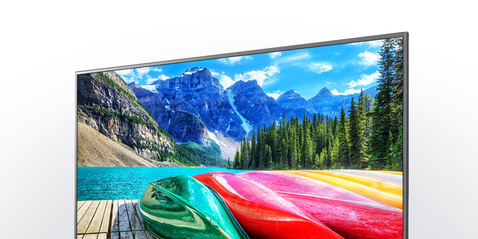 tv with image of boats, river, and mountain in the background