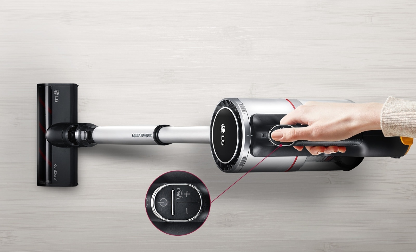 Image of hand holding a cordless stick vacuum, close up image of ON button including Turbo mode.