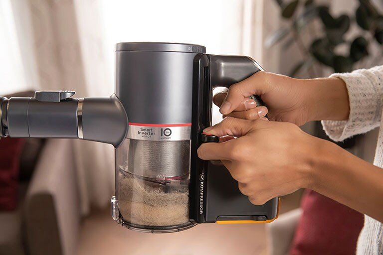 close up of a hand holding the vacuum handle