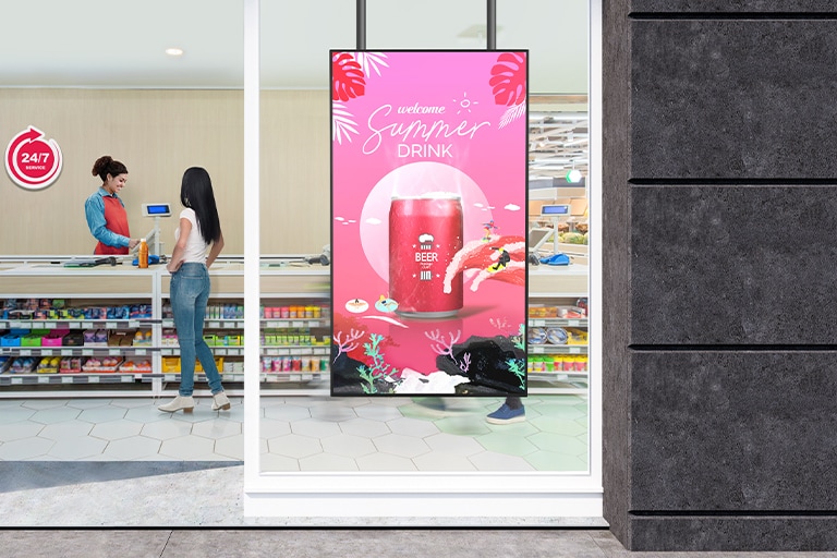A large LED display is installed on the window inside the convenience store, vividly and brightly showcasing advertisements through the glass.