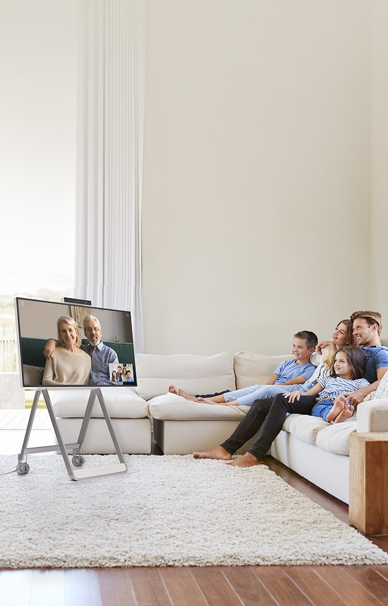 " A family is making a video call using the product in the living room"