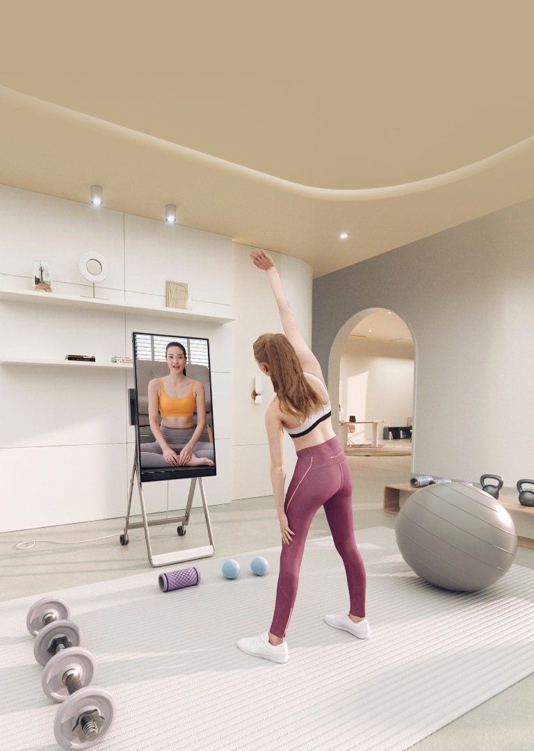 An Image of a young woman exercising while watching a video