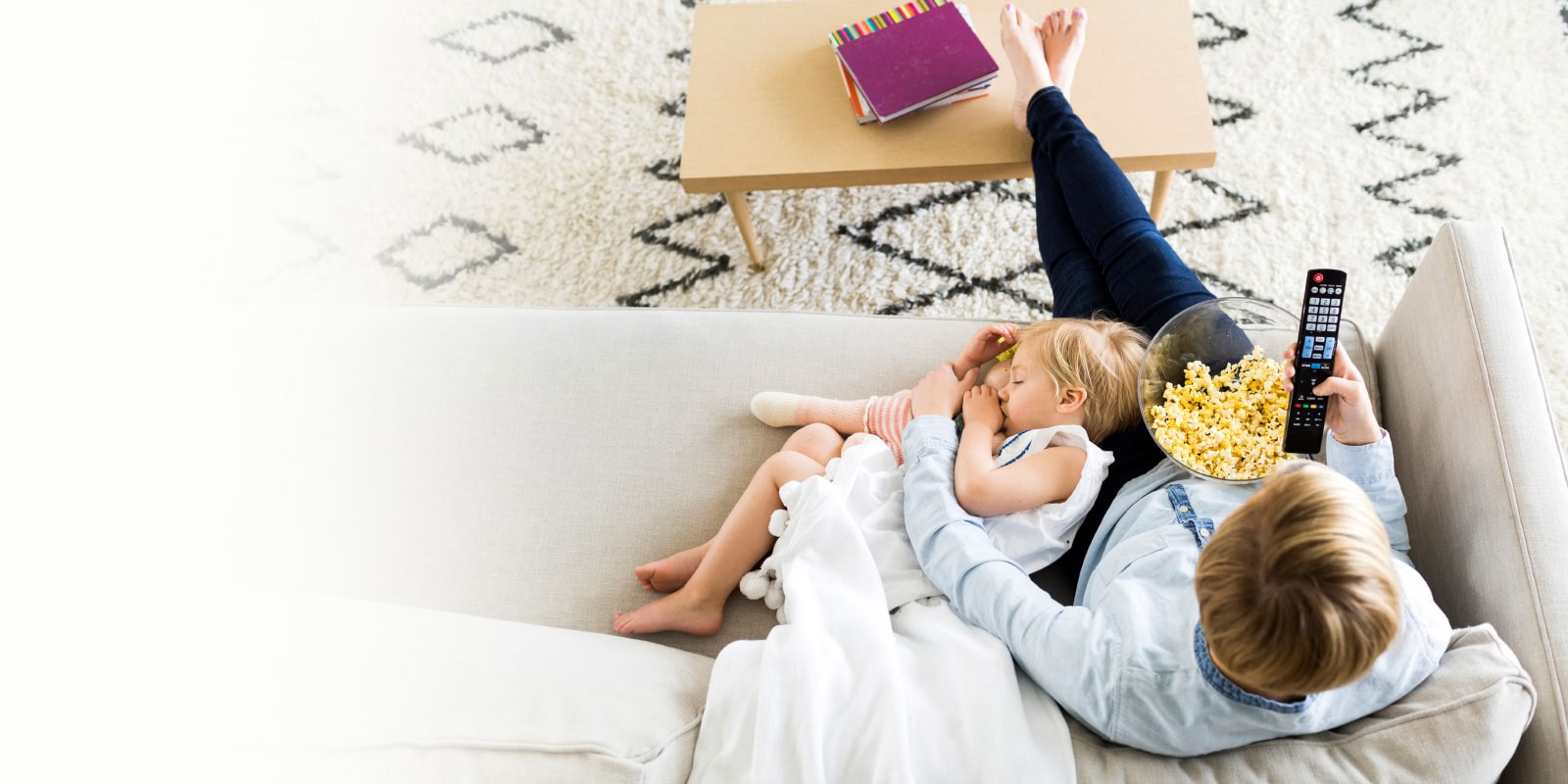 Adult and child sitting on couch