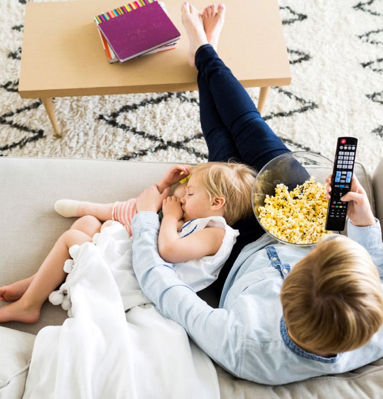 Adult and child sitting on couch