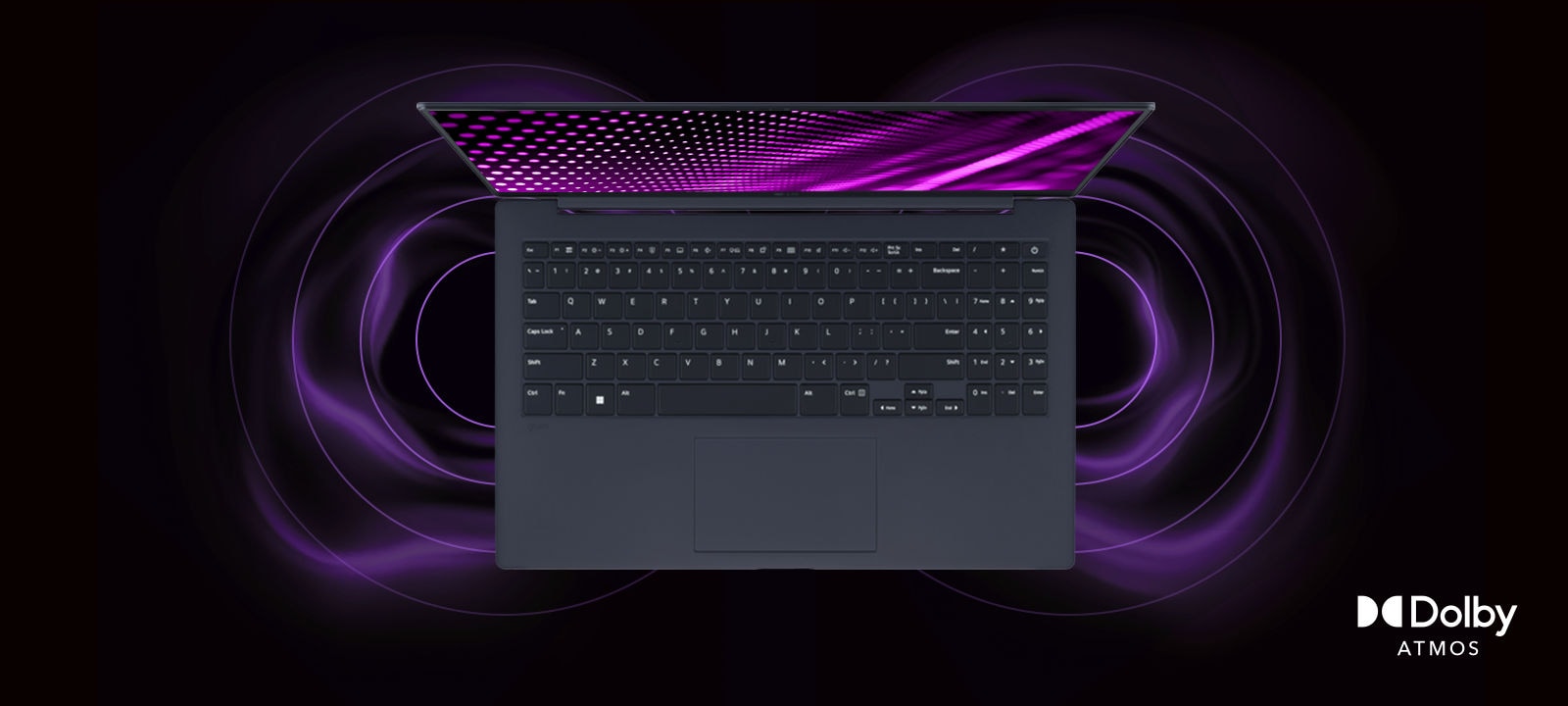 The image shows a top-down view of a gray laptop with a vibrant, purple-themed graphic on the screen. Surrounding the laptop are dynamic sound wave visuals, indicating an immersive audio experience. The "Dolby Atmos" logo is displayed in the bottom right corner.