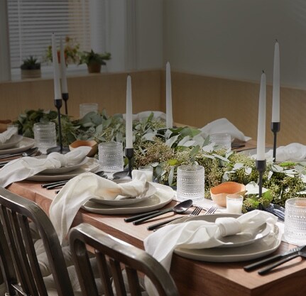 festive dinner table with candles and plates