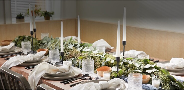 festive dinner table with candles and plates