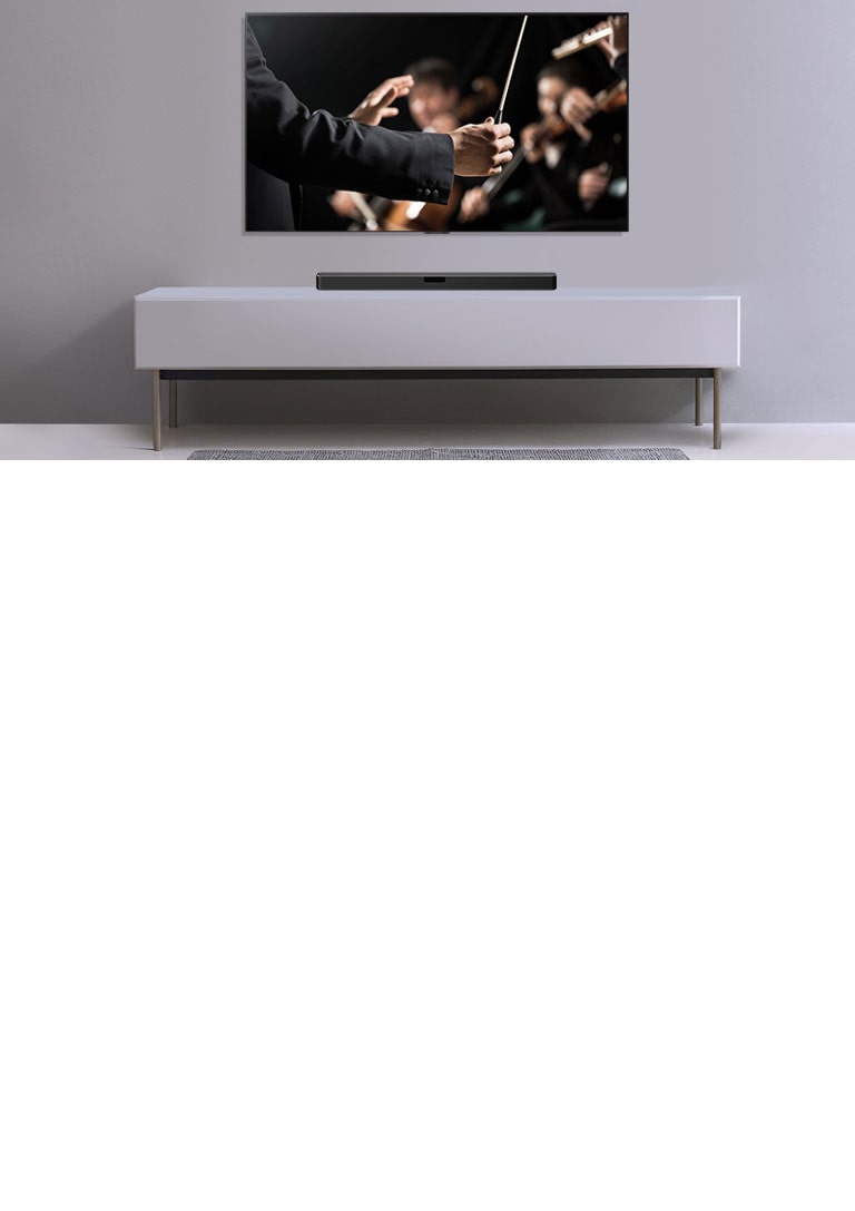 A TV is shown on a gray wall and LG Soundbar below it on a gray shelf. TV shows a conductor conducting an orchestra.