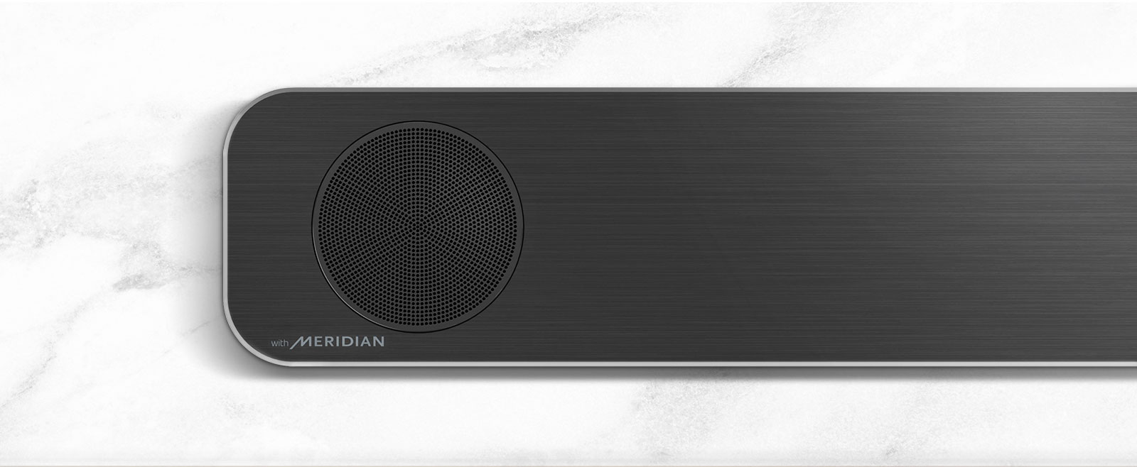 Close-up of the left side of LG Soundbar with Meridian logo on the bottom left corner.