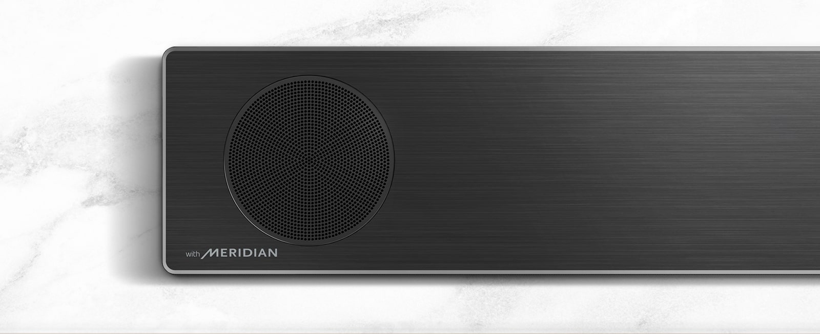 Close-up of the left side of LG Soundbar with Meridian logo on the bottom left corner.