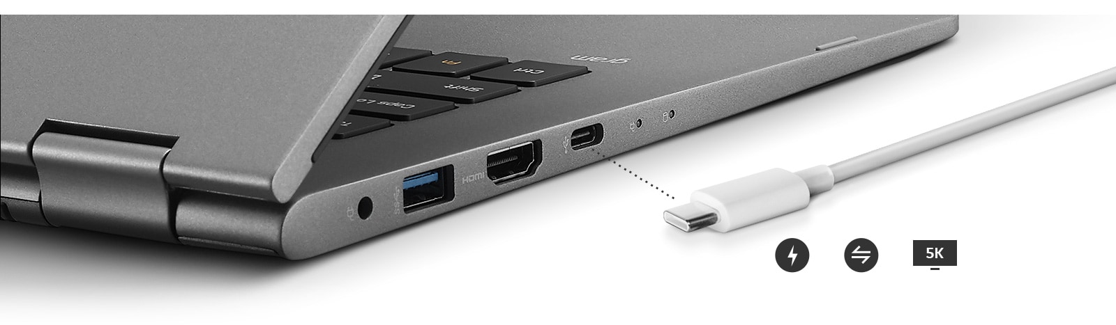 Image of a side view of the laptop with close up of outputs and a charger