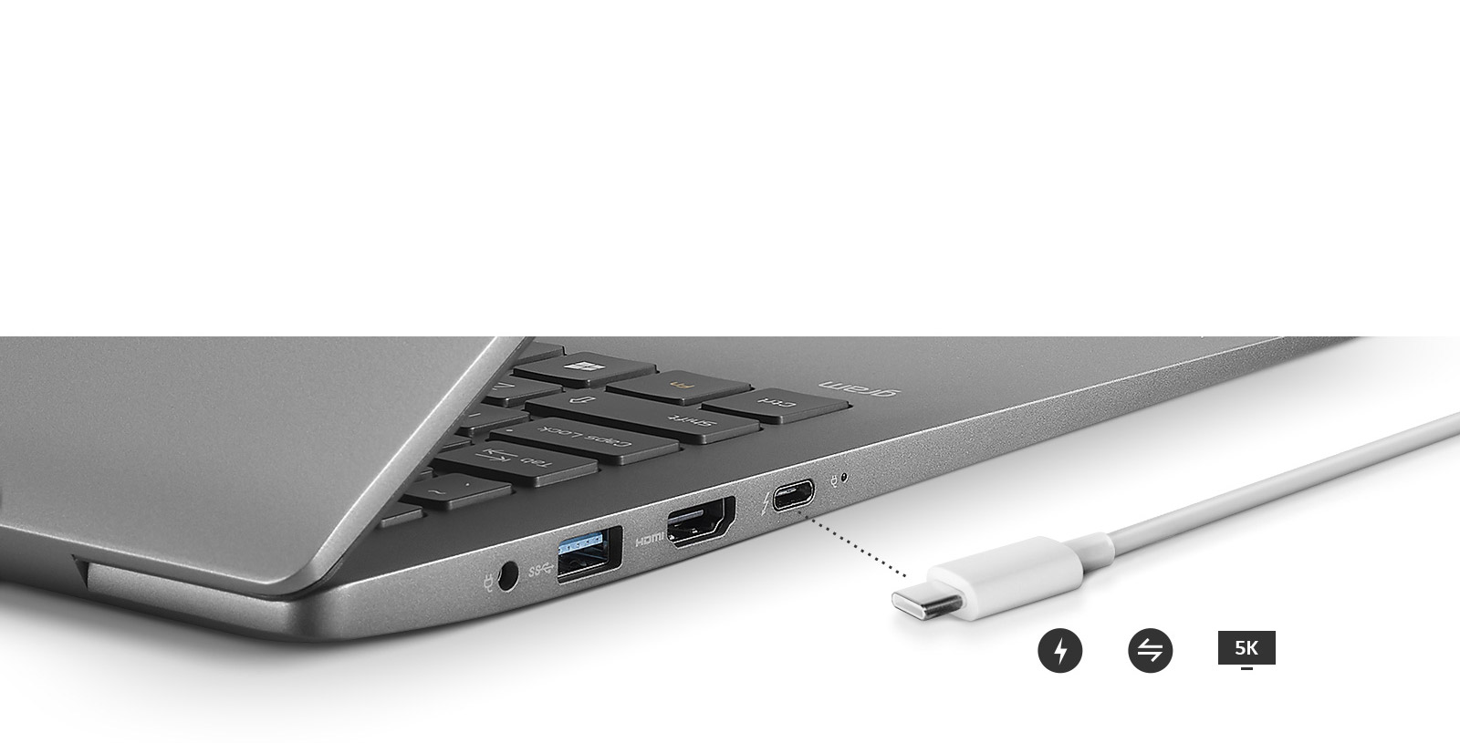 Image of a side view of the laptop with close up of outputs and a charger