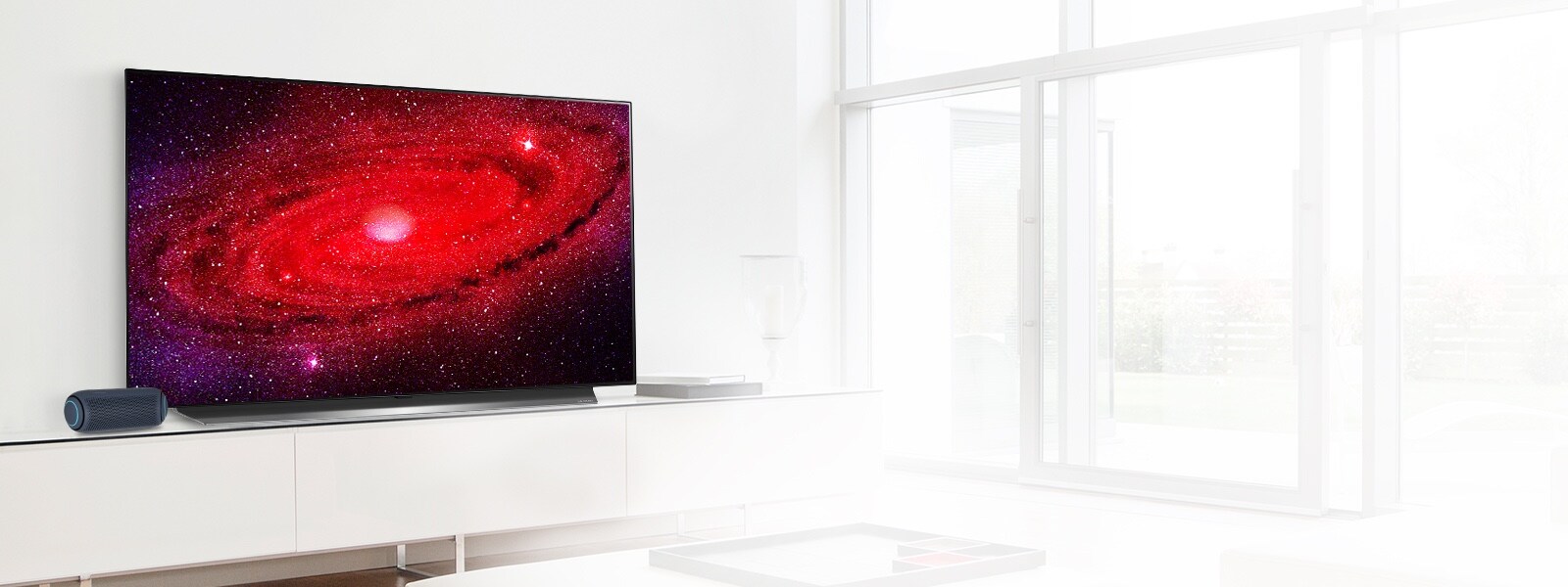 LG TV with PL5 portable speaker in a living room