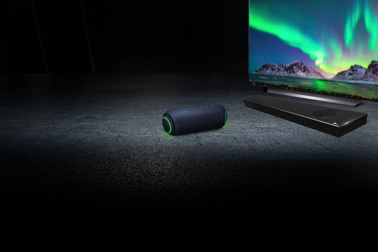 XBOOM speaker next to LG OLED TV and sound bar