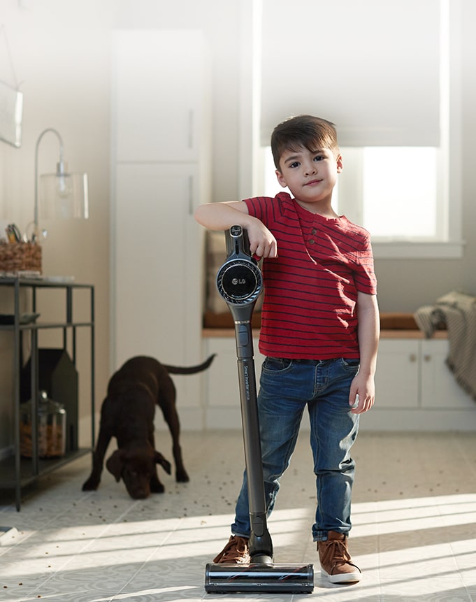 a boy with LG vacuum