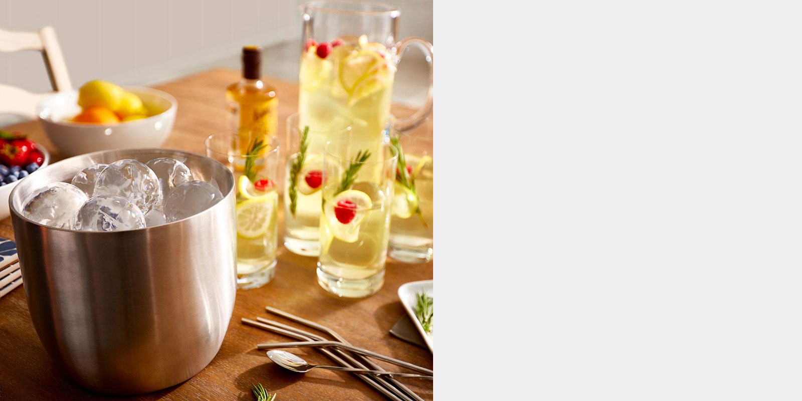 Styled Craft Ice in a bucket next to a lemonade pitcher and glasses