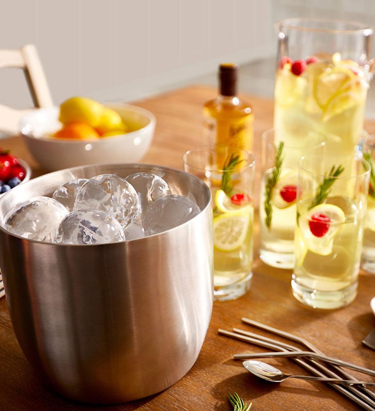 Styled Craft Ice in a bucket next to a lemonade pitcher and glasses