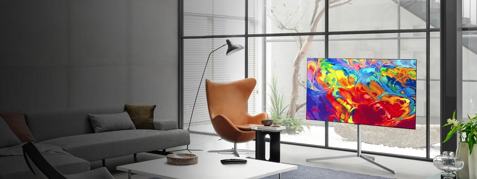 Office lobby with OLED TV next to chair and coffee table