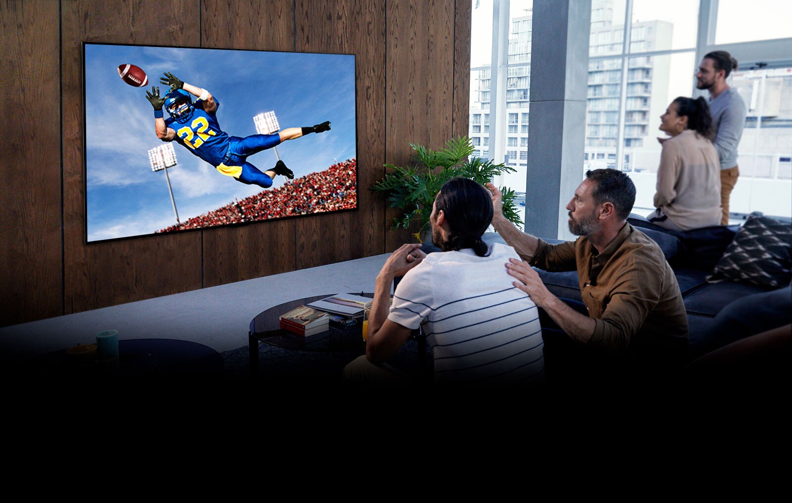 People watching a Tottenham game on TV in the living room